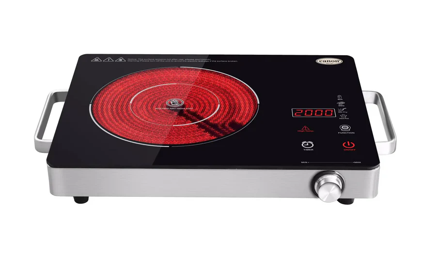 The CHA-CCT1-01-4.webp is a single burner electric infrared cooker with a glowing red heating element, digital display, control knob, touch buttons, metal side handles, and the CANDY brand label on its sleek black surface.