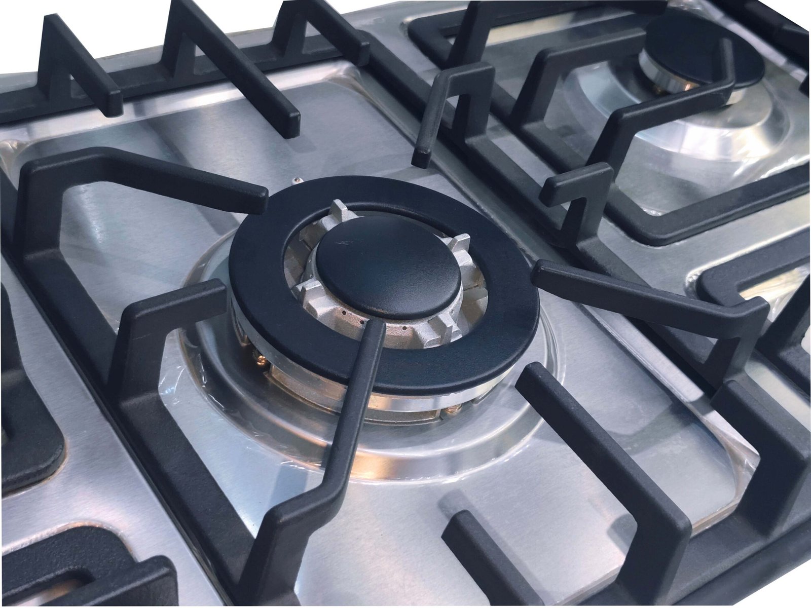 Close-up of IMG_20240927_213728-scaled-1.jpg: a stainless steel gas hob featuring two black burners with cast iron pan supports. The clean, reflective surface highlights the burner caps and supporting frames.